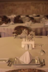 a table with a plate with a napkin on it at Hotel Eken Prestige in Bandırma