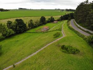 an aerial view of a field with a road at Anniston Mill Cabin 1 in Arbroath