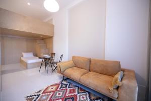 a living room with a brown couch and a table at Seaside Residence in Vlorë