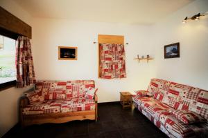 a living room with two couches and a couch at Chalet De La Tour - entièrement rénové et confortable MAE-3503 in Tignes