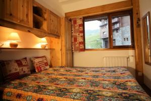 a bedroom with a bed and a window at Chalet De La Tour - entièrement rénové et confortable MAE-3503 in Tignes +5 photos