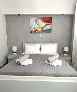 a bedroom with a bed with two towels on it at Athena Apartment in Argostoli