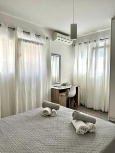 a bedroom with a bed with towels on it at Athena Apartment in Argostoli