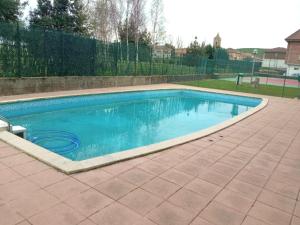 a swimming pool with blue water in a yard at Betula Pendula - 12601 in Ajo