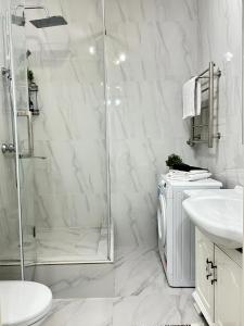 a bathroom with a shower and a toilet and a sink at 30# Galileo Terrace in Almaty +45 photos