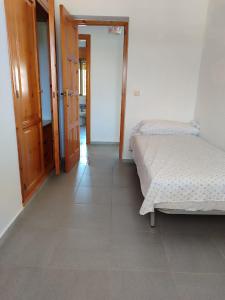 a room with two beds and a hallway with two doors at Picacho in Mazagón