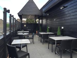an outdoor seating area with tables and chairs at The Craighaar Hotel in Aberdeen