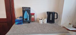 a counter with a blender and other items on it at Large Double room near London Heathrow Airport in Hayes