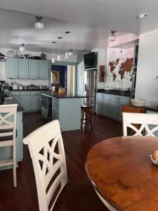a kitchen with blue cabinets and a wooden table at Hudson House Bed and Breakfast in Wheatland