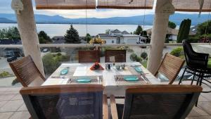 a table on a patio with a view of the water at Lakeview Oasis Bed and Breakfast in West Kelowna