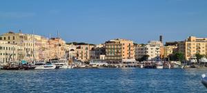 a group of boats docked in a harbor with buildings at La Maison sul Porto in Anzio