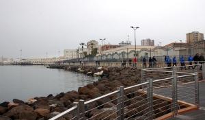 a group of people standing on a pier near the water at Numero 3 in Cagliari