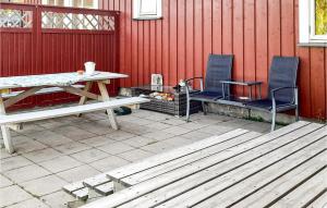 a picnic table and two chairs on a patio at 3 Bedroom Nice Home In Råde in Råde