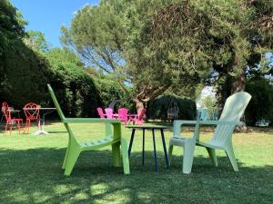 a group of chairs and a table in the grass at Brit Hotel Dak Hotel in Avallon
