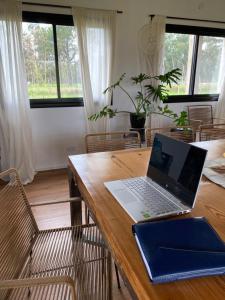 a laptop computer sitting on top of a wooden table at La Pinocha de Ruiz in Ruiz