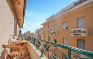 a balcony with a table and chairs on a building at Amazing Apartment In Chiavari With Wifi in Chiavari +12 photos