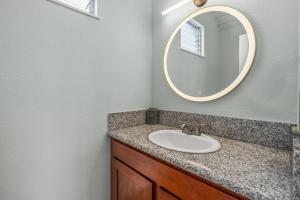 a bathroom with a sink and a mirror at Contemporary 2-BR Condo AC & Scenic Views in PV in Princeville