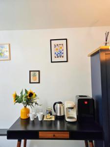 a table with a coffee maker and flowers on it at River Haven Edinburgh in Edinburgh +57 photos