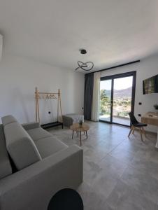 a living room with a couch and a table at Villa Selini in Skala Potamias