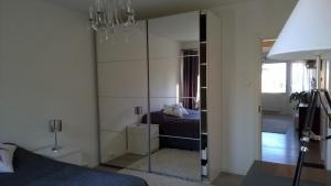 a bedroom with a mirrored closet and a bed at City Apartment Snellmaninkatu 22 A in Kuopio