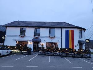 a large white building with a rainbow flag on it at the berg's 09 in Ocna-Mureşului