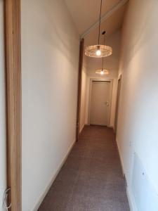 an empty hallway with a door and a chandelier at the berg's 09 in Ocna-Mureşului
