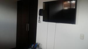 TV a/nebo společenská místnost v ubytování Hotel Casa Suite Curiti