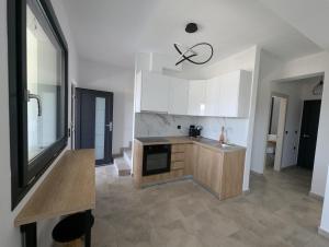 a kitchen with white cabinets and a counter top at Villa Selini in Skala Potamias