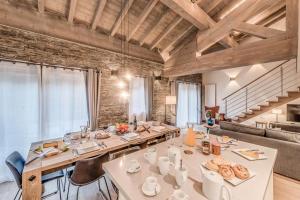 a dining room with a long table with chairs at Résidence Eagle Lodge - En chalet 6 Pièces duplex 4 - 124m2 MAE-3964 in Tignes +24 photos