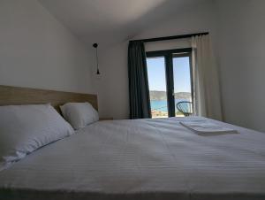 a bedroom with a bed with a view of the ocean at Villa Selini in Skala Potamias