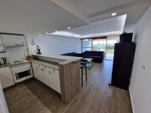 a kitchen and a living room with a counter top at malibu bay resort in Ed Dkârîne +4 photos
