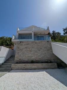 a house with a staircase leading up to it at Villa Selini in Skala Potamias