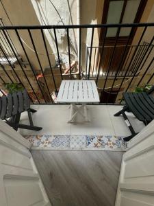a table and two chairs in front of a staircase at Caminneci Palace Boutique in Palermo