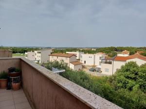 a view of a city from the balcony of a building at Eco friendly apartment in Ližnjan