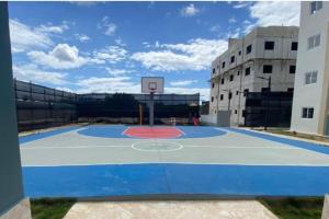 a basketball court in a building with a basketball hoop at Disfruta, te lo mereces in La Romana