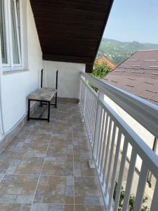 a balcony of a house with a bench on it at Old town Suburb Apartment in Sarajevo
