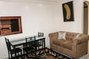 a living room with a couch and a table at MJ-Homes Eldoret 2 Bedroom in Eldoret