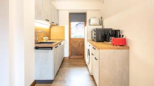 a small kitchen with a sink and a refrigerator at Le Chalet De Montchavin - Magnifique appartement rénové MAE-4234 in La Plagne Tarentaise