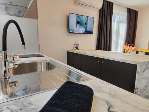 a kitchen with a sink and a counter top at студио Водолей in Obzor +36 photos