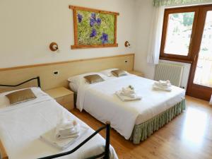 Ένα ή περισσότερα κρεβάτια σε δωμάτιο στο Hotel Garnì Maffei