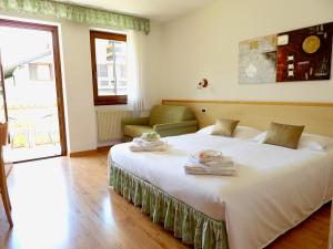 Ένα ή περισσότερα κρεβάτια σε δωμάτιο στο Hotel Garnì Maffei