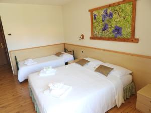 Ένα ή περισσότερα κρεβάτια σε δωμάτιο στο Hotel Garnì Maffei
