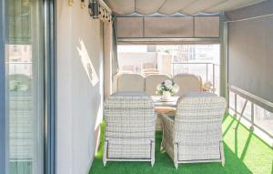 a balcony with a table and chairs on a balcony at Beautiful Apartment In Torrevieja in Torrevieja