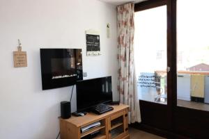 a living room with a flat screen tv on a wall at Nouvelles Residences - Studio équipé pour 4 personnes MAE-7774 in Tignes