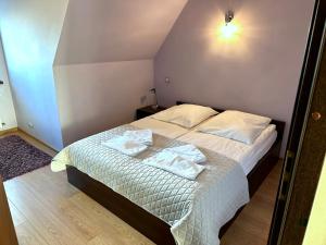 Una cama o camas en una habitación de Apartamenty Viva Tatry
