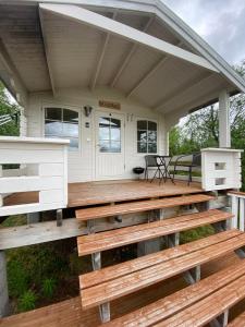a tiny house with a porch and benches at Sara's cabins-hytter in Kautokeino +9 photos