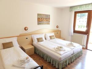 Ένα ή περισσότερα κρεβάτια σε δωμάτιο στο Hotel Garnì Maffei