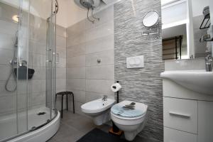 a bathroom with a toilet and a sink and a shower at Apartment Bellevue in Vodnjan +29 photos