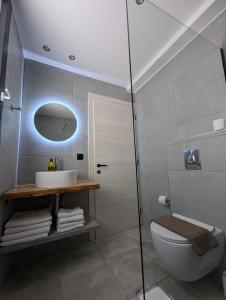 a bathroom with a toilet and a sink and a shower at Villa Selini in Skala Potamias +14 photos