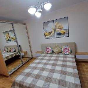 a room with a couch and some pictures on the wall at Apartament Lux in Chişinău +2 photos
